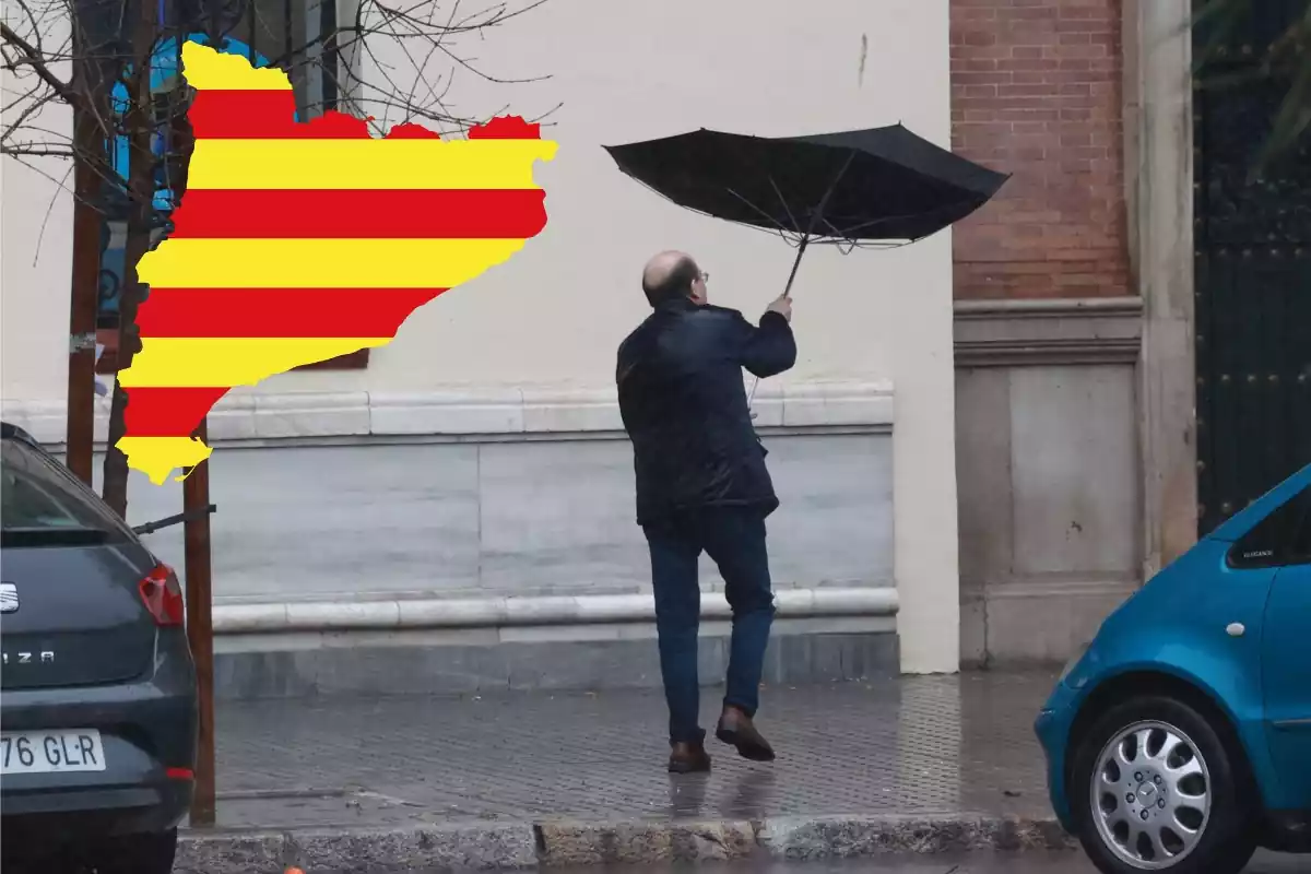 Hombre con el paraguas al revés con el mapa de Cataluña y la bandera